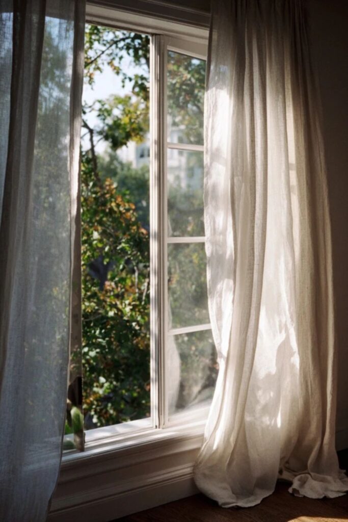 14. An Open Window With Linen Curtains