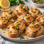 Lemon garlic shrimp crostini bites topped with parsley and lemon zest